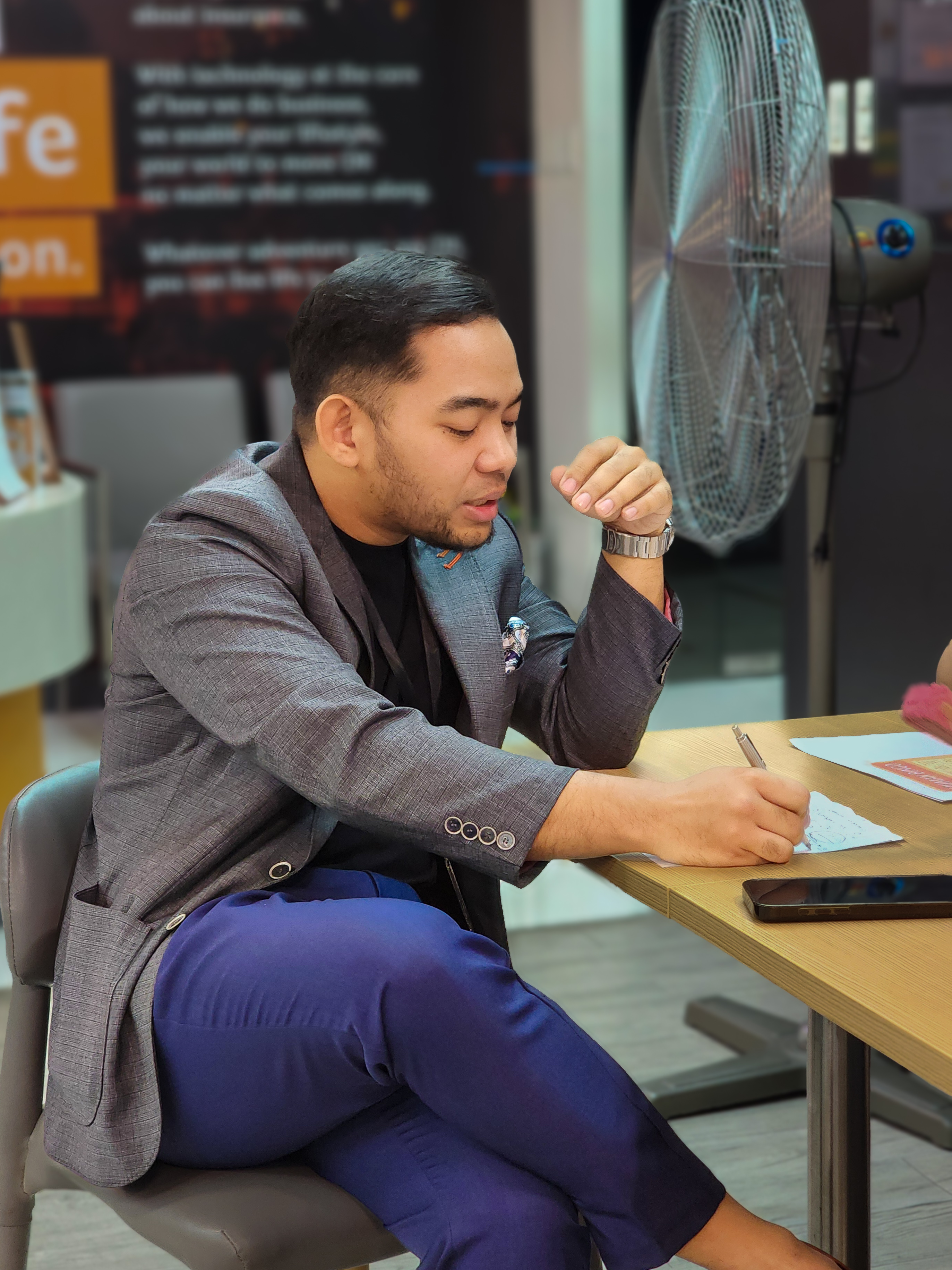 Jayr speaking with a client during a consultation